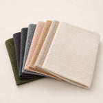 Thumbnail for Stack of folded Bouclé bed runners in green, grey, beige and ivory shades