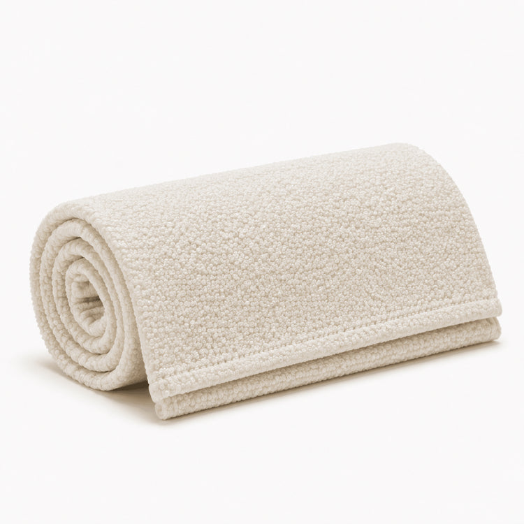 Rolled Ivory Bouclé bed runner on a white background