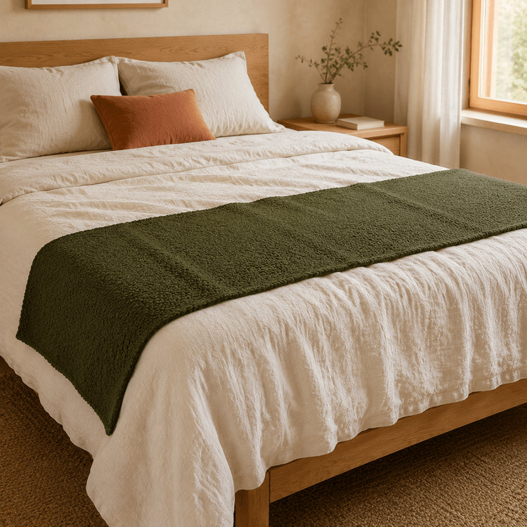 Moss Green Bouclé bed runner across the foot of a neutral bed