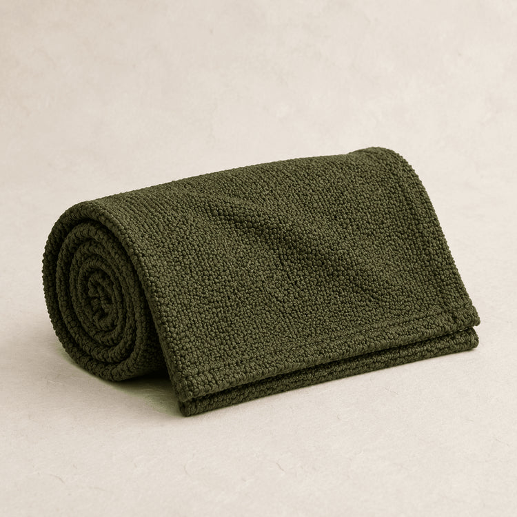 Rolled Moss Green Bouclé bed runner on a neutral background
