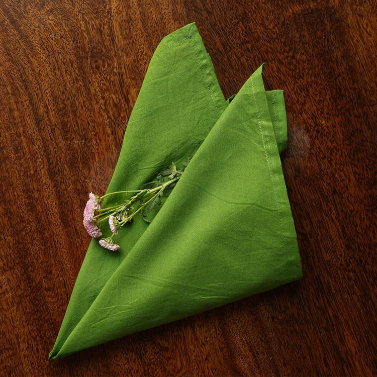 Solid-dyed cotton cambric napkins folded for a dining table