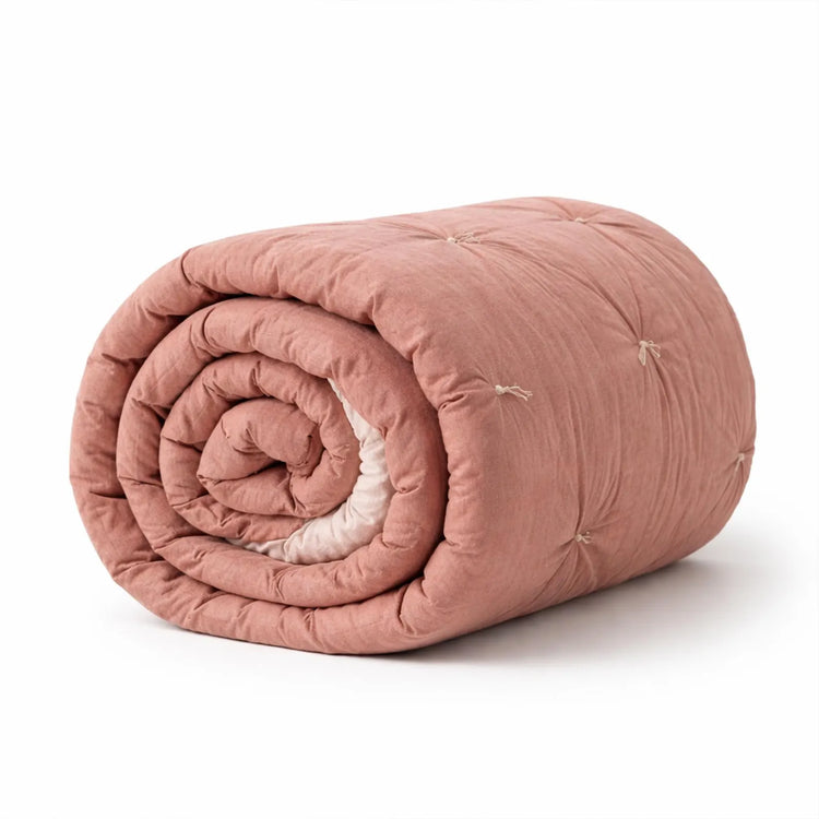 Handmade Cotton Velvet Quilt in Blush Pink, rolled and styled shot