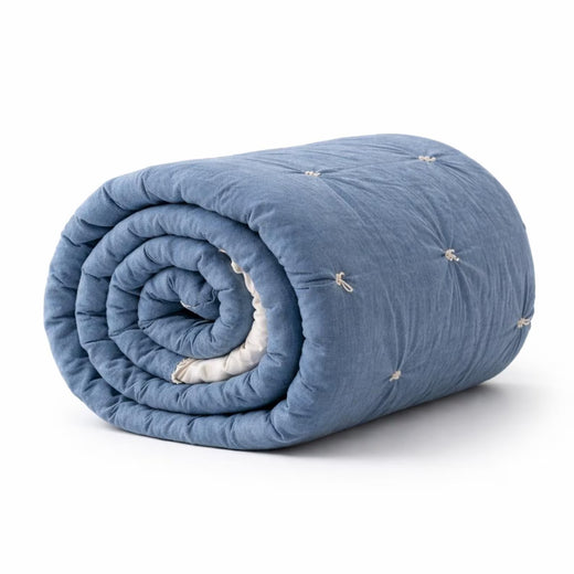 Handmade Cotton Velvet Quilt in Smoke Blue, rolled up showing tufted texture and hand-knotted tassels