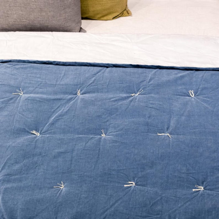 Handmade Cotton Velvet Quilt in Smoke Blue, hand-knotted tassel detail close-up